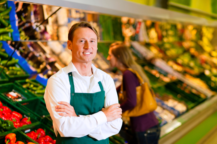 Man in supermarket as shop assistant